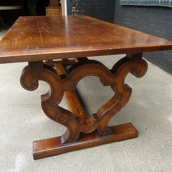 Customized solid oak dining table with shaped scrolled base