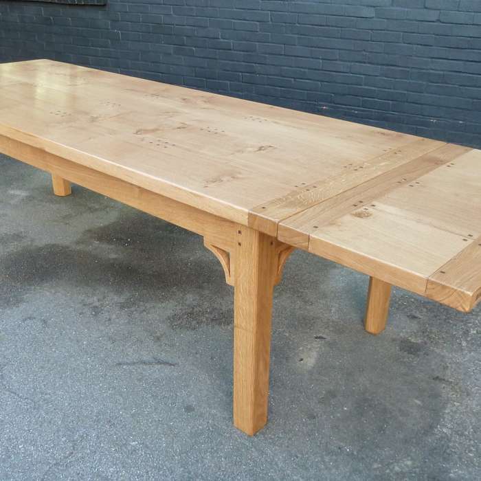 Solid oak Table with extending leaves and square legs with fine carved brackets