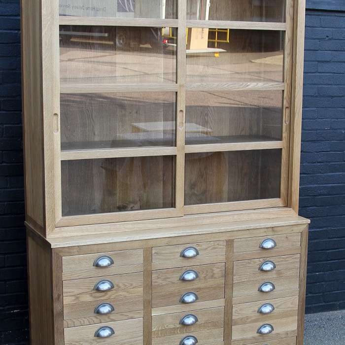 A 2 door sliding glazed cabinet with filing drawers