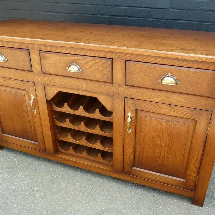 Solid oak three drawer side board with drink rack